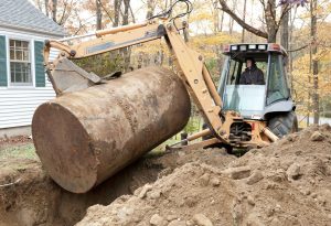 Excavator removing an underground oil tank